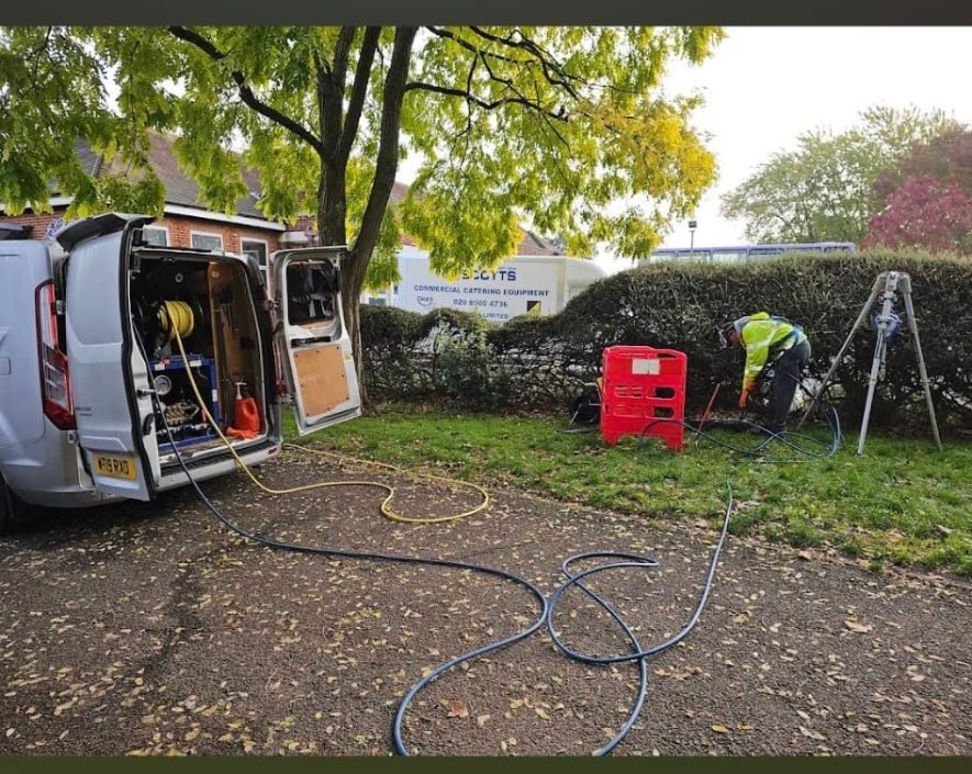Drain Force engineer high-pressure jetting and rodding a blocked drain with the van and equipment set up on site